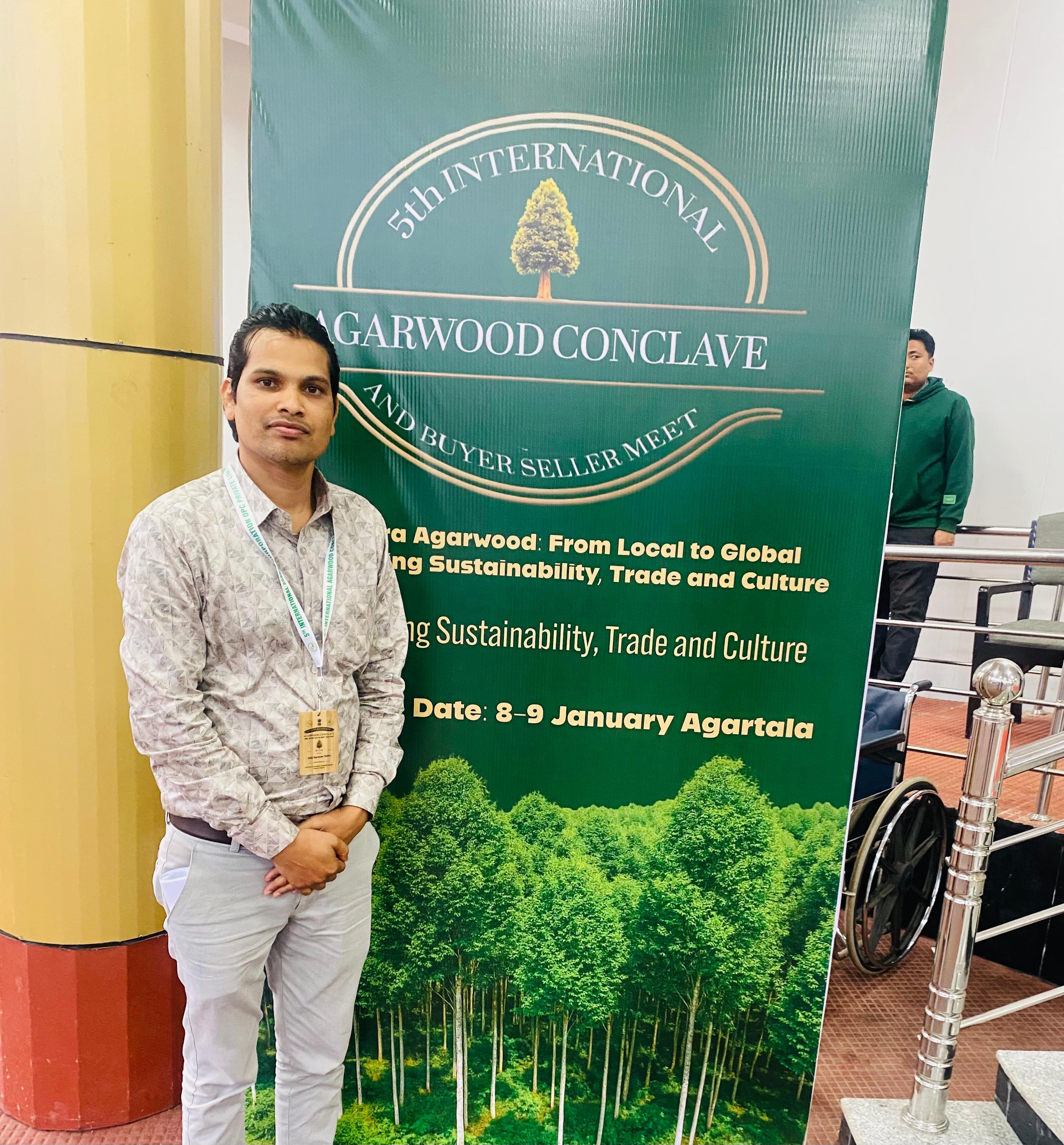Farmer planting agarwood saplings