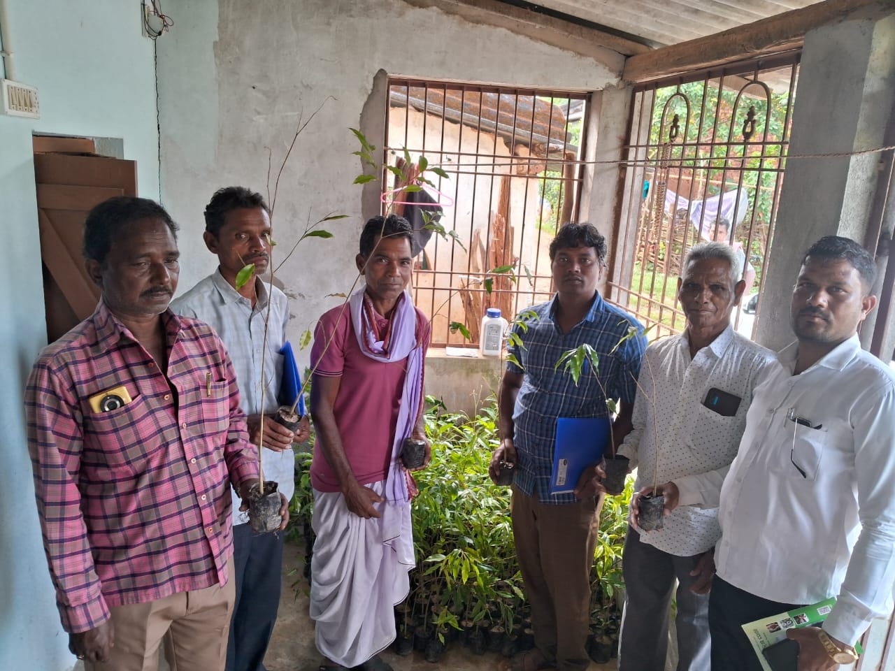 Farmer planting agarwood saplings