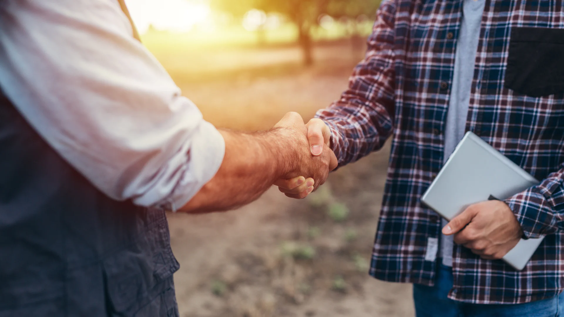 Farmer and company representative signing buy back agreement
